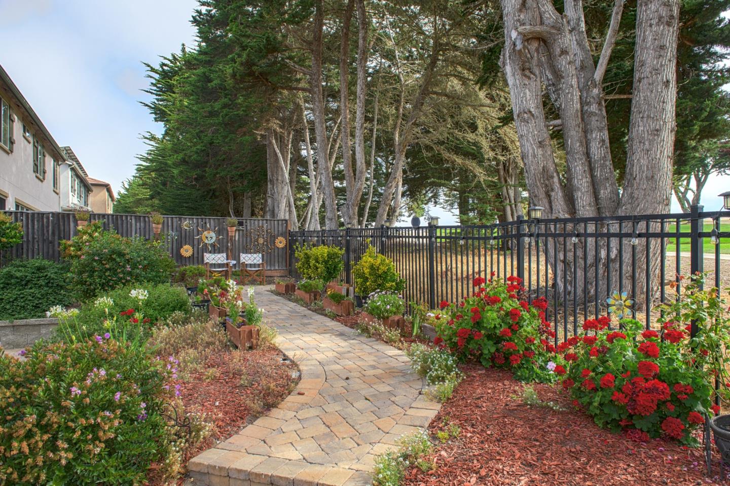4190 Peninsula Point Drive Seaside, CA 93955 - Photo 28 of 30 a view of a garden with flowers and trees