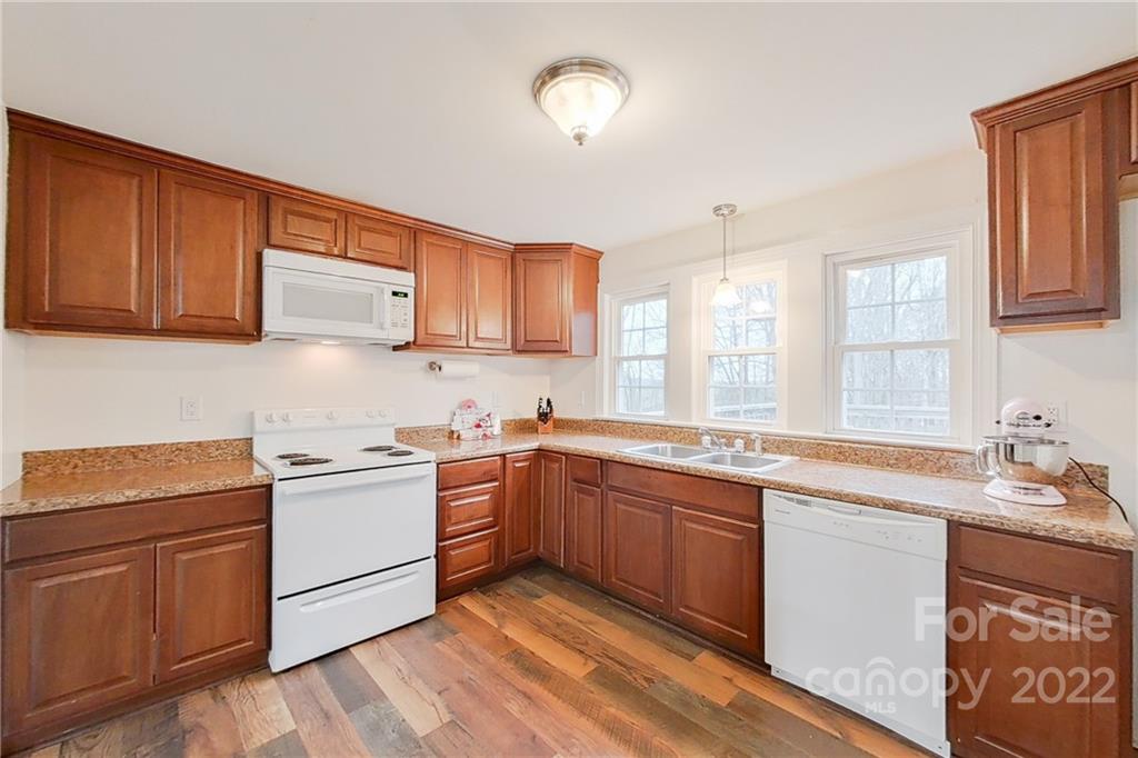 3701 Parkwood School Road Monroe, NC 28112 - Photo 19 of 36 a kitchen with a sink stove and cabinets