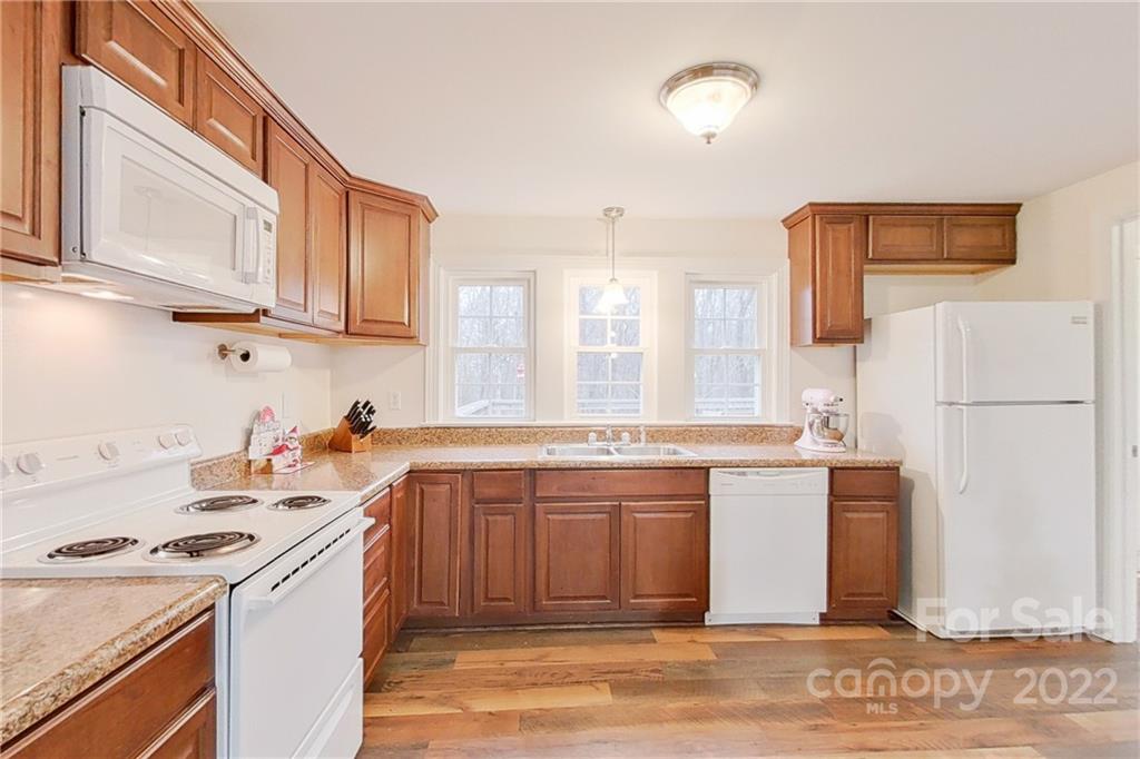 3701 Parkwood School Road Monroe, NC 28112 - Photo 21 of 36 a kitchen with stainless steel appliances granite countertop a stove a sink dishwasher and a refrigerator