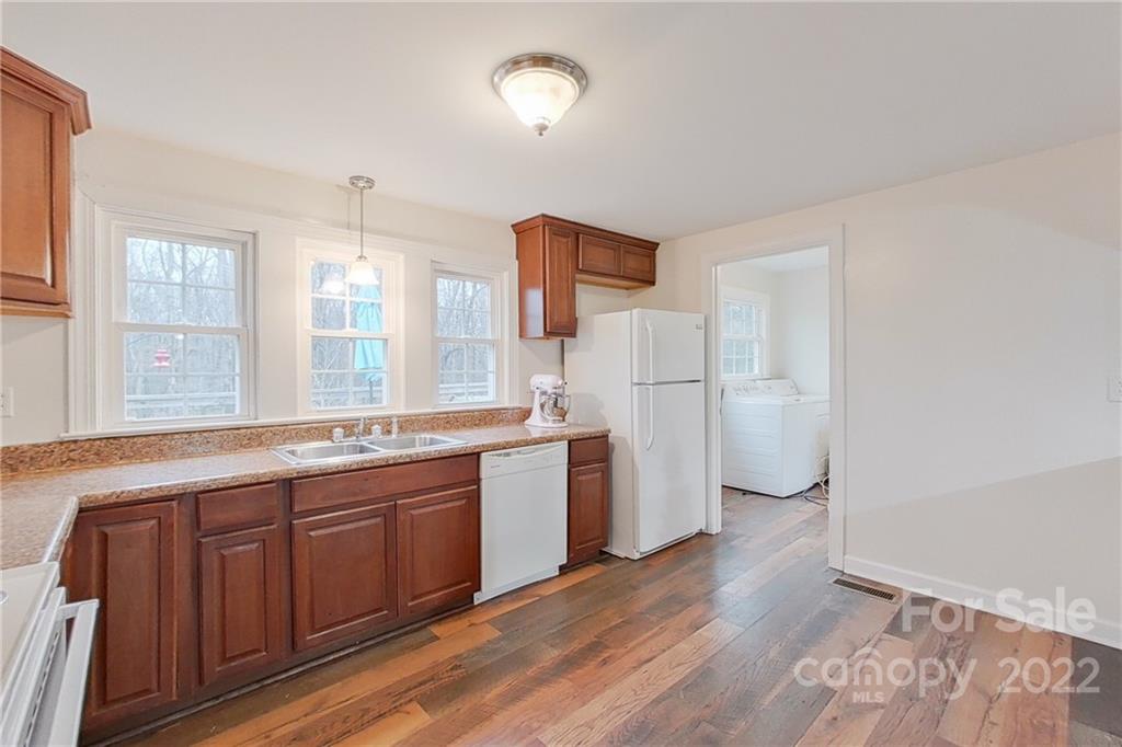 3701 Parkwood School Road Monroe, NC 28112 - Photo 22 of 36 a open kitchen with a sink dishwasher a refrigerator and a stove with wooden floor