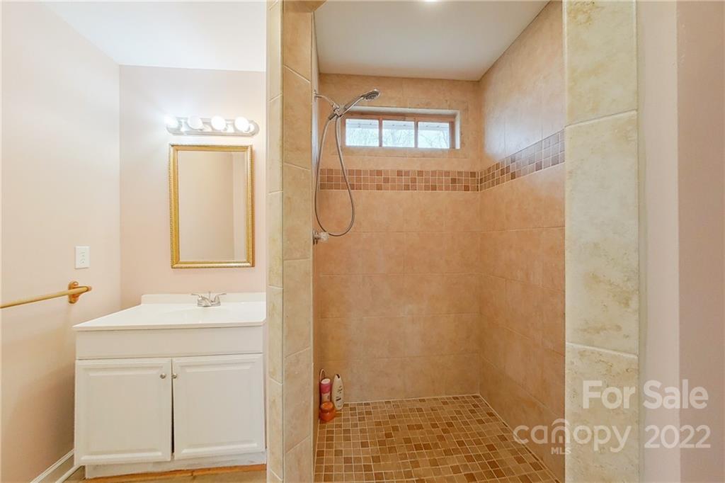 3701 Parkwood School Road Monroe, NC 28112 - Photo 24 of 36 a bathroom with a sink a mirror and shower