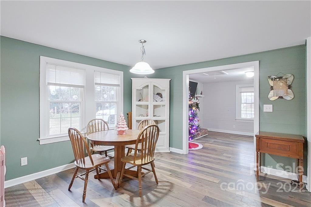3701 Parkwood School Road Monroe, NC 28112 - Photo 27 of 36 a dining room with furniture a chandelier and wooden floor