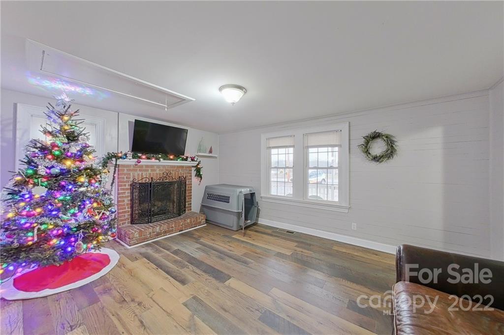 3701 Parkwood School Road Monroe, NC 28112 - Photo 30 of 36 a living room with furniture a flat screen tv and a fireplace