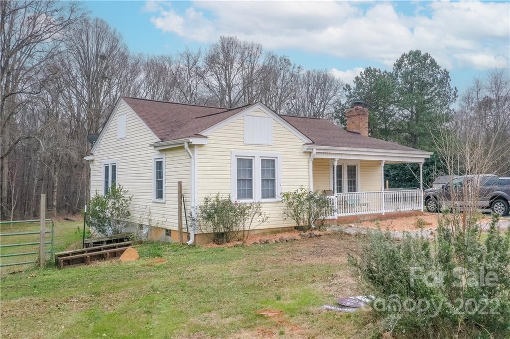 3701 Parkwood School Road Monroe, NC 28112 - Photo 3 of 36 a front view of house with a garden and patio
