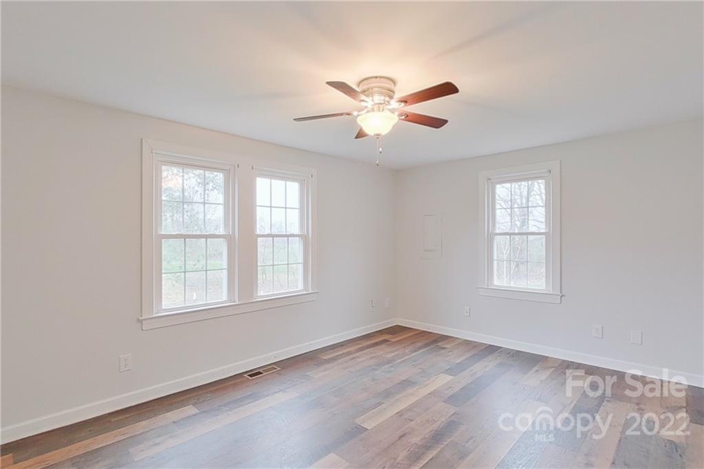 3701 Parkwood School Road Monroe, NC 28112 - Photo 35 of 36 a view of an empty room with wooden floor and a window