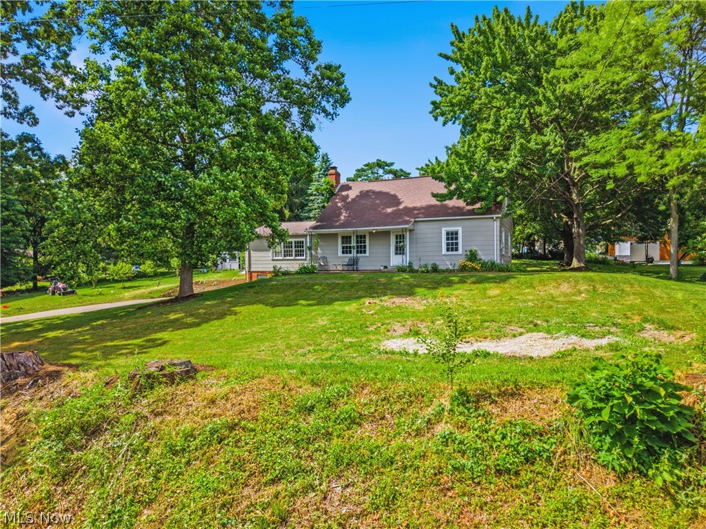 1769 Paradise Road Orrville, OH 44667 - Photo 36 of 36 Expansive green lawn with mature trees and a gray-sided residence