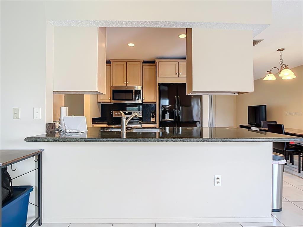 5964 Diana Road Venice, FL 34293 - Photo 11 of 27 a kitchen with stainless steel appliances granite countertop a sink and a stove