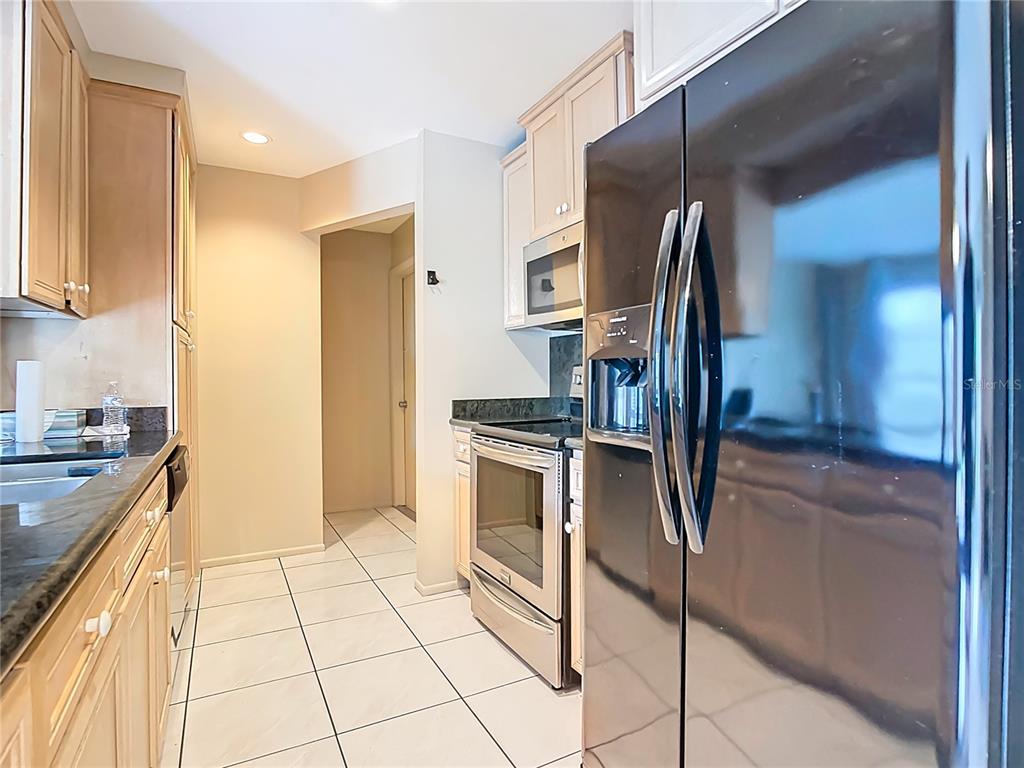 5964 Diana Road Venice, FL 34293 - Photo 13 of 27 a kitchen with stainless steel appliances granite countertop a refrigerator and a stove