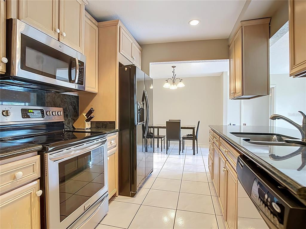 5964 Diana Road Venice, FL 34293 - Photo 14 of 27 a kitchen with a stove cabinets and microwave