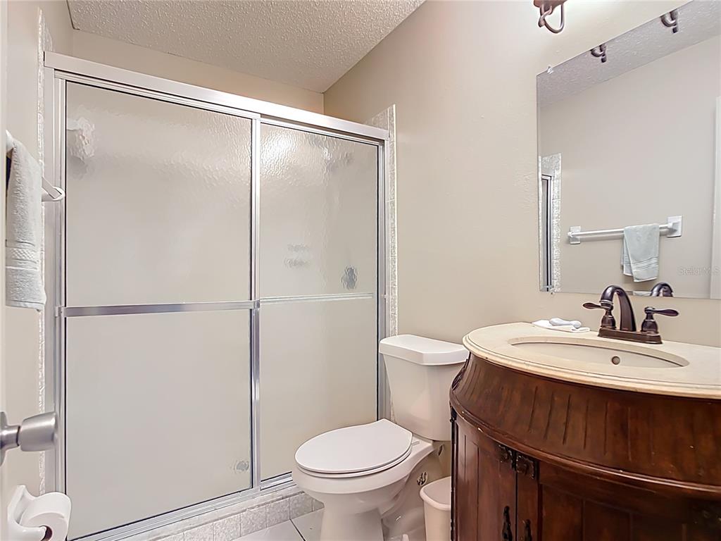 5964 Diana Road Venice, FL 34293 - Photo 17 of 27 a bathroom with a sink toilet and shower