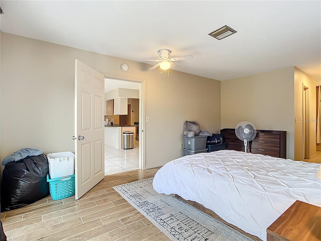 5964 Diana Road Venice, FL 34293 - Photo 18 of 27 a bedroom with a bed and a chandelier