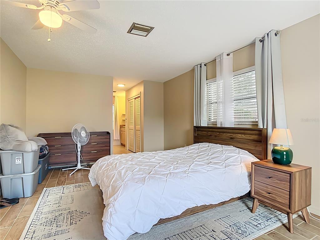 5964 Diana Road Venice, FL 34293 - Photo 19 of 27 a bedroom with a bed and wooden floor