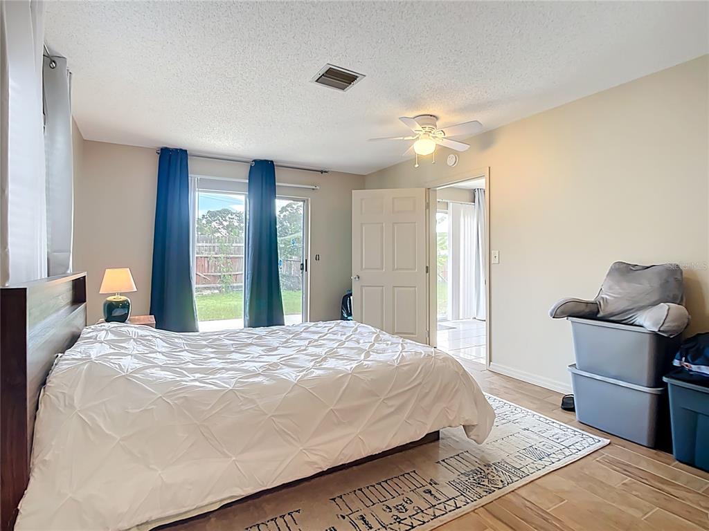 5964 Diana Road Venice, FL 34293 - Photo 20 of 27 a bedroom with a bed and a chandelier