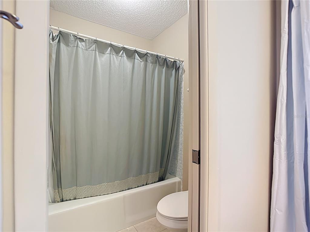 5964 Diana Road Venice, FL 34293 - Photo 23 of 27 a bathroom with a shower curtain and sink