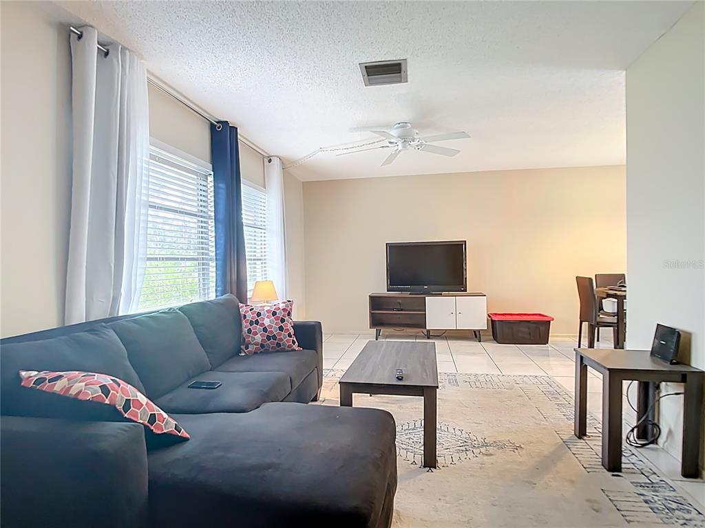 5964 Diana Road Venice, FL 34293 - Photo 3 of 27 a living room with furniture and a flat screen tv