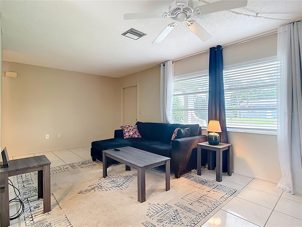 5964 Diana Road Venice, FL 34293 - Photo 5 of 27 a living room with furniture a chandelier and a window