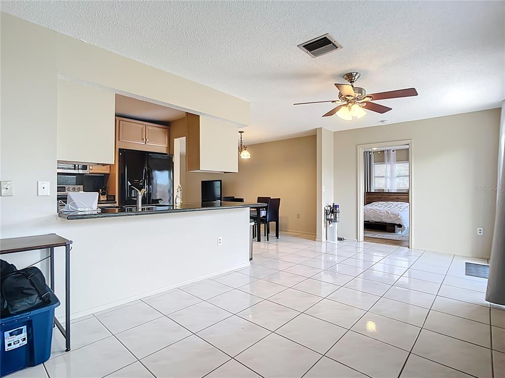 5964 Diana Road Venice, FL 34293 - Photo 10 of 27 a view of a kitchen with furniture and a ceiling fan