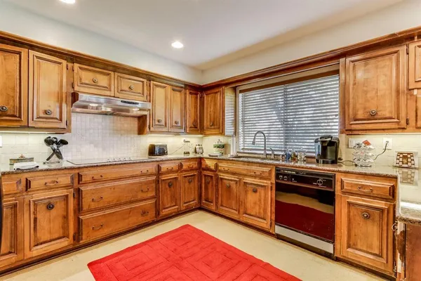 a kitchen with stainless steel appliances granite countertop a stove sink and cabinets