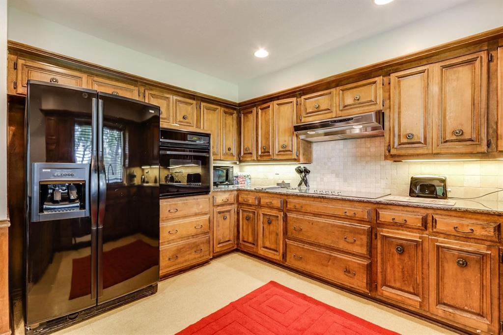 9310 Waterview Road Dallas, TX 75218 - Photo 16 of 35 a kitchen with stainless steel appliances granite countertop a refrigerator and a stove top oven