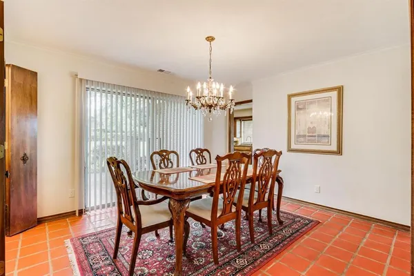 a dining room with furniture and chandelier