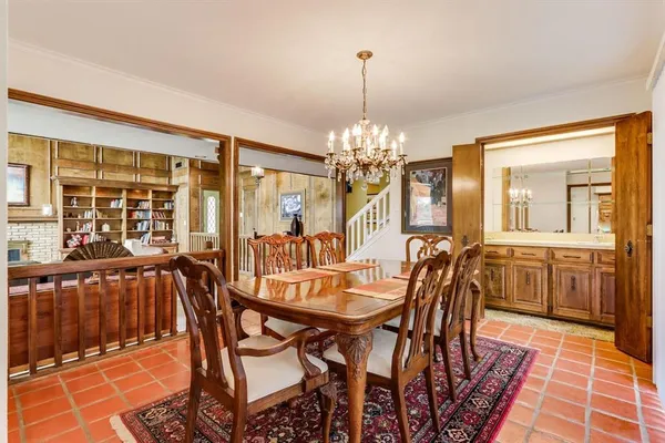 a view of a dining room with furniture and chandelier