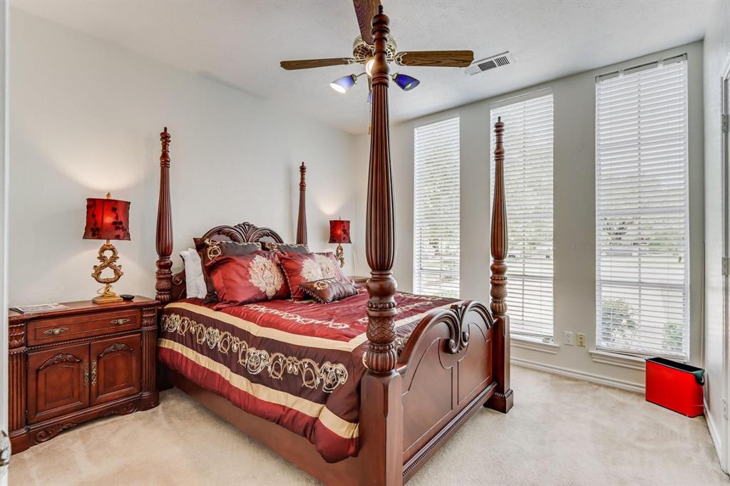 9310 Waterview Road Dallas, TX 75218 - Photo 21 of 35 a bedroom with a bed and a chandelier