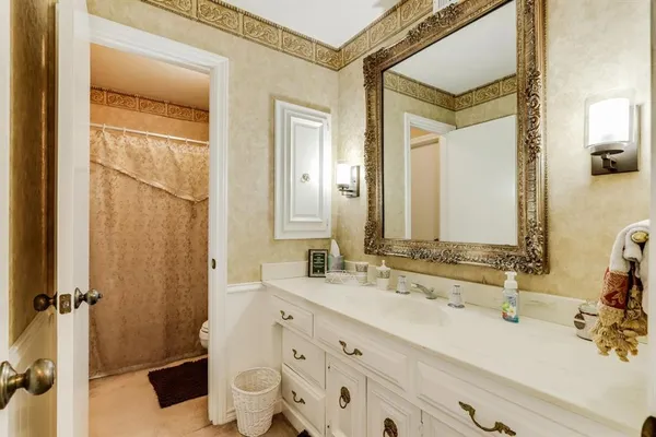 a bathroom with a double vanity sink toilet and shower