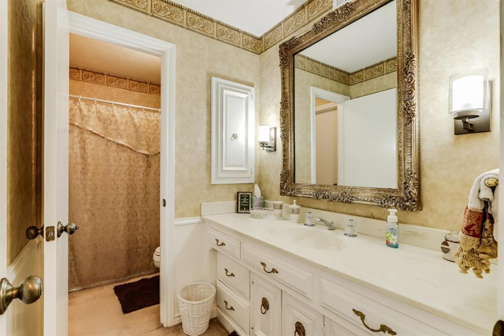 9310 Waterview Road Dallas, TX 75218 - Photo 23 of 35 a bathroom with a double vanity sink toilet and shower