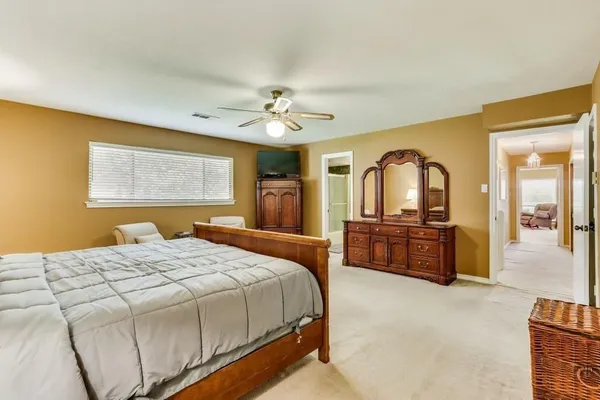 a bedroom with a large bed and a dresser
