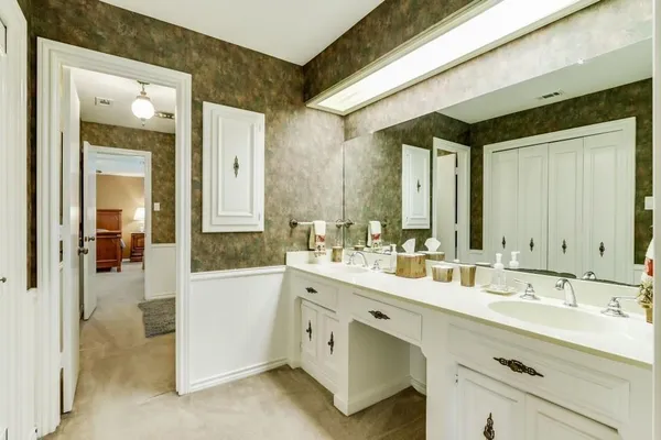 a spacious bathroom with a double vanity sink mirror and