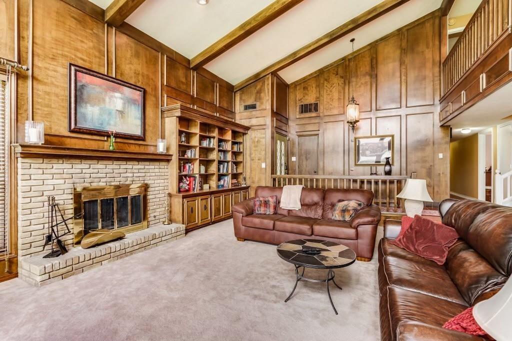 9310 Waterview Road Dallas, TX 75218 - Photo 9 of 35 a living room with furniture a fireplace and a flat screen tv