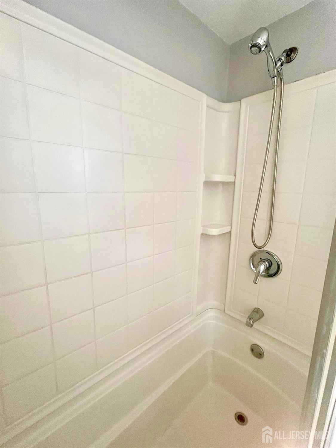 213 Temple Way, Unit 2 Colonia, NJ 07067 - Photo 11 of 16 a bathroom with a shower and a bath tub