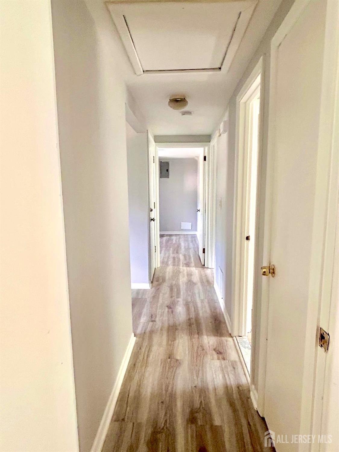 213 Temple Way, Unit 2 Colonia, NJ 07067 - Photo 12 of 16 a view of a room with wooden floor and a bathroom