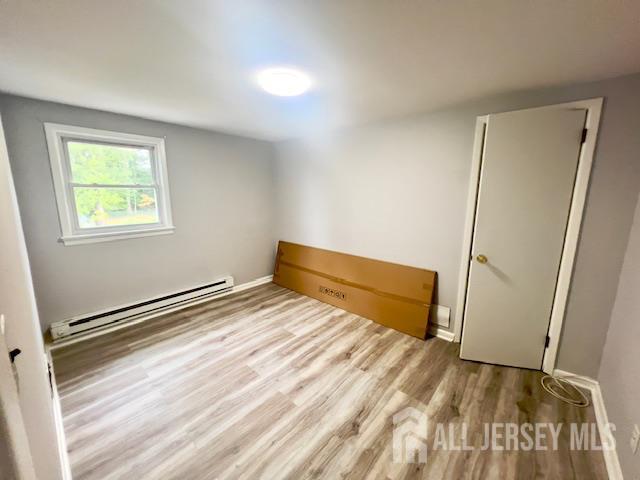 213 Temple Way, Unit 2 Colonia, NJ 07067 - Photo 13 of 16 a view of room with window and wooden floor