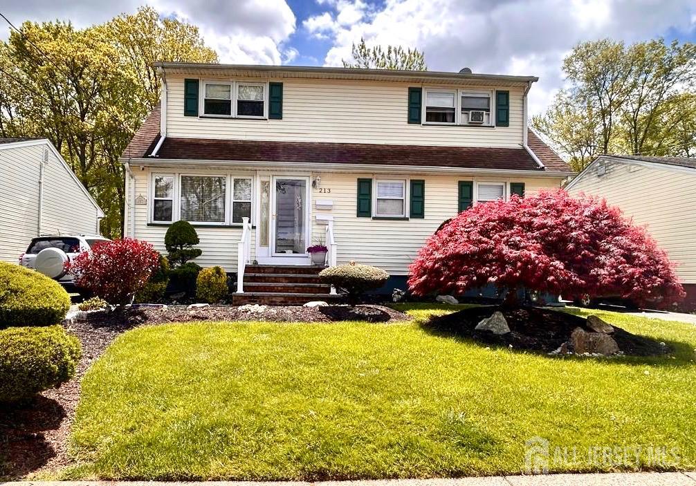 213 Temple Way, Unit 2 Colonia, NJ 07067 - Photo 16 of 16 a front view of house with yard and trees