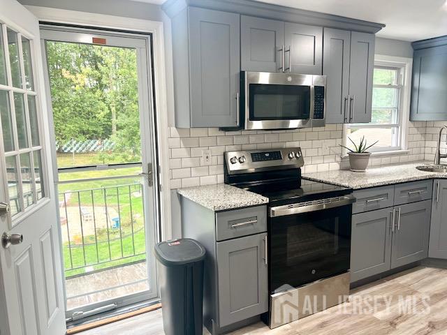 213 Temple Way, Unit 2 Colonia, NJ 07067 - Photo 2 of 16 a kitchen with a stove and a sink