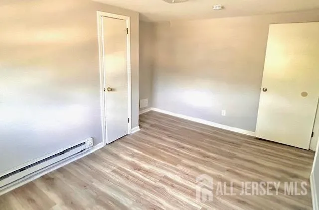 a view of a room with wooden floor