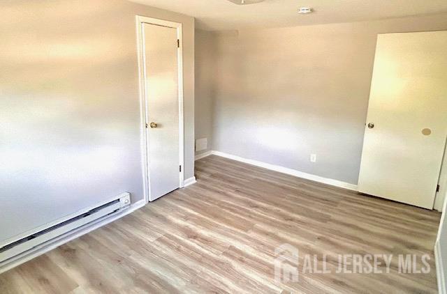 213 Temple Way, Unit 2 Colonia, NJ 07067 - Photo 7 of 16 a view of a room with wooden floor