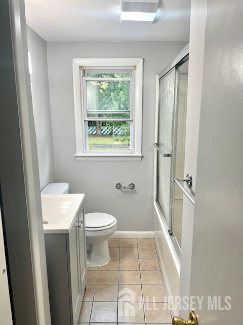 213 Temple Way, Unit 2 Colonia, NJ 07067 - Photo 9 of 16 a bathroom with a toilet a sink and a window