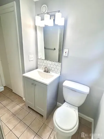 a white toilet sitting next to a bathroom sink