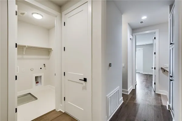 a view of a hallway with a wooden floor