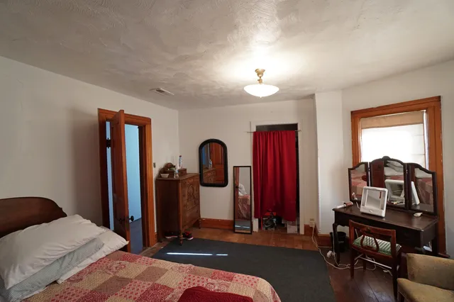 a view of a bedroom with furniture and chandelier