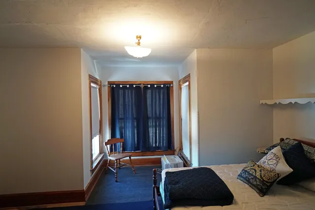 a bedroom with bed and a window