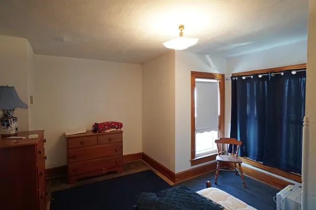 a view of room with hardwood floor and cabinet