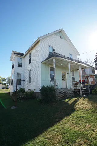 a front view of a house with a garden and patio