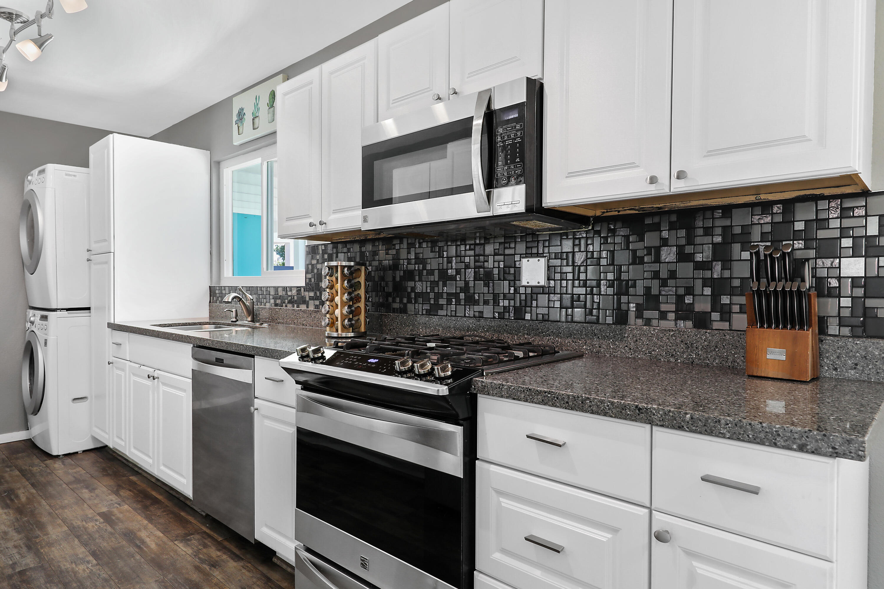 70171 Chappel Road Rancho Mirage, CA 92270 - Photo 13 of 38 a kitchen with granite countertop white cabinets and stainless steel appliances