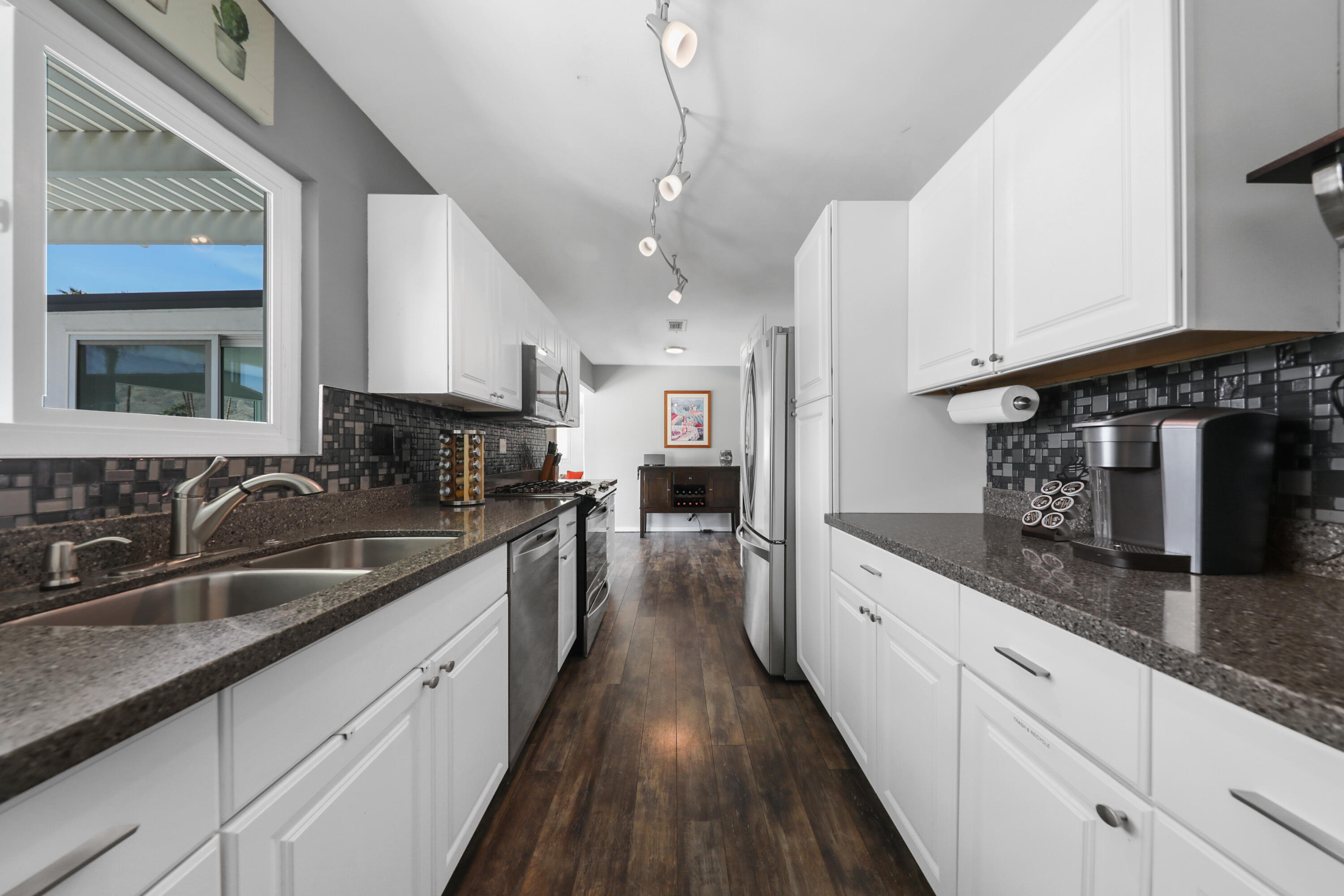 70171 Chappel Road Rancho Mirage, CA 92270 - Photo 15 of 38 a kitchen with granite countertop a sink and cabinets