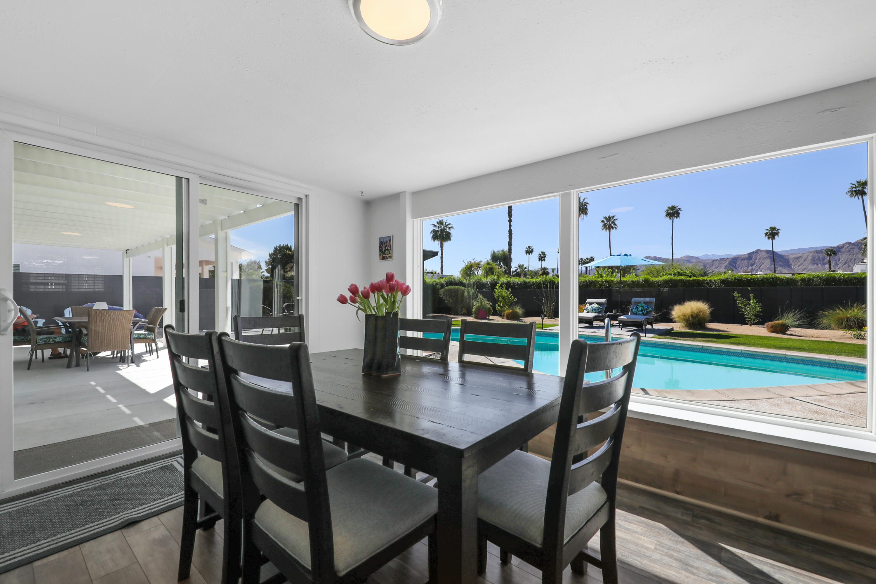70171 Chappel Road Rancho Mirage, CA 92270 - Photo 16 of 38 a view of a dining room with furniture and wooden floor
