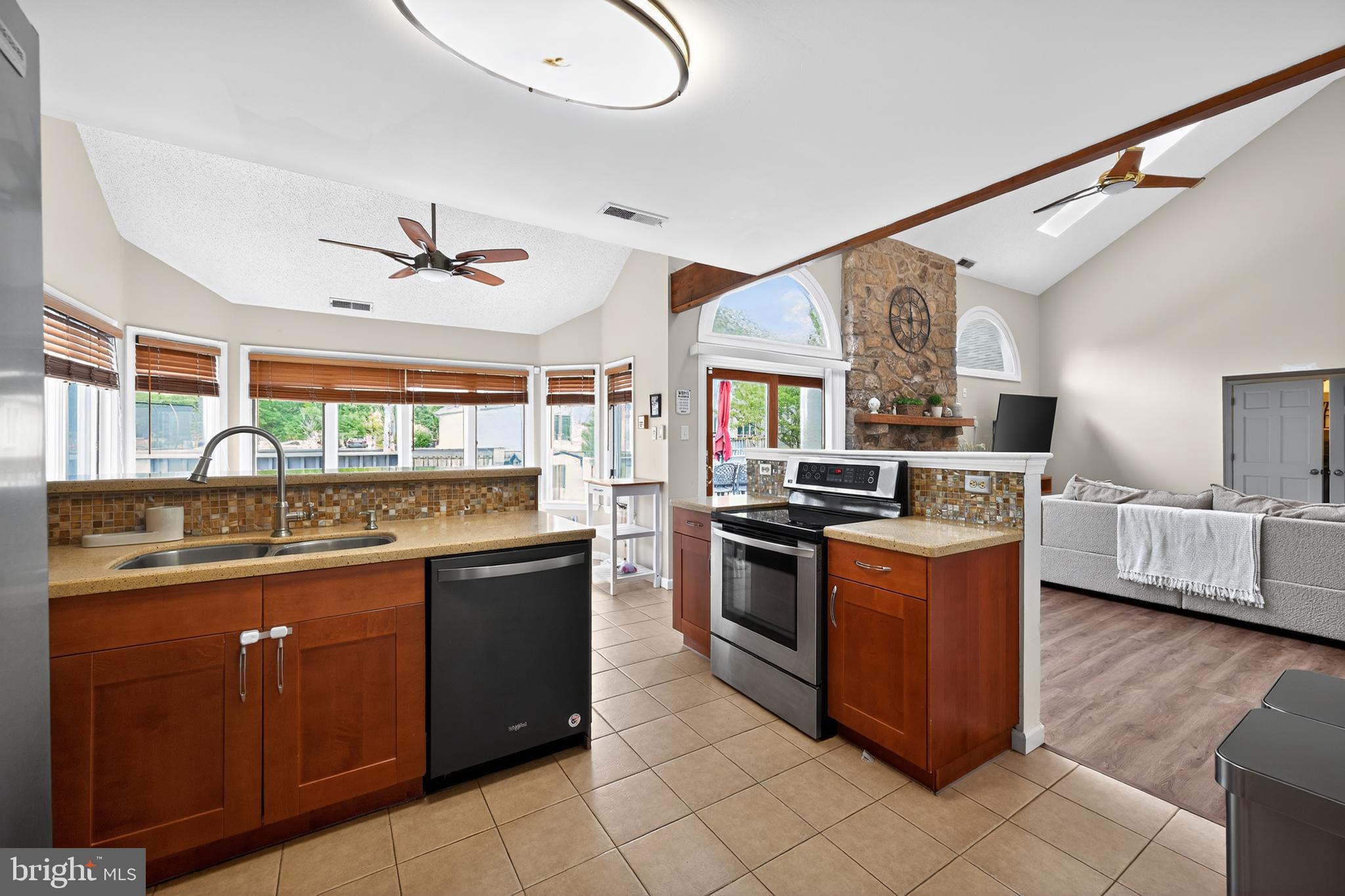 1656 South Ash Circle Jamison, PA 18929 - Photo 7 of 30 a kitchen with stainless steel appliances granite countertop a stove and a sink