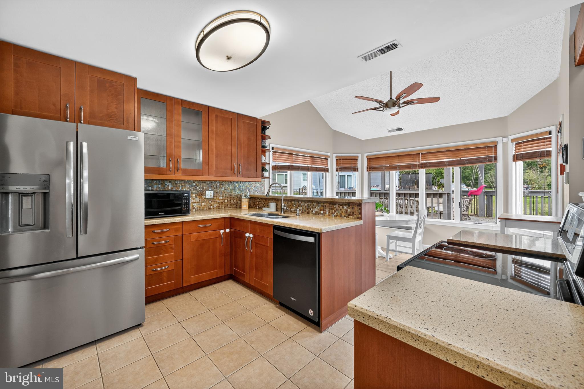 1656 South Ash Circle Jamison, PA 18929 - Photo 8 of 30 a kitchen with stainless steel appliances granite countertop a sink a stove and a refrigerator